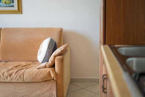 a couch with a pillow on it in a room at La Caletta 2 in La Caletta