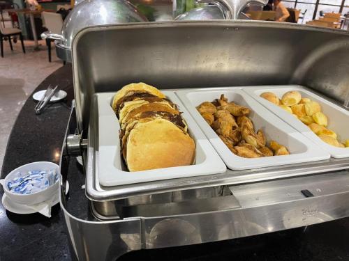 a tray with a sandwich and other food items at Beira Mar - Flat Beach Class Internacional - Boa Viagem 20º andar in Recife