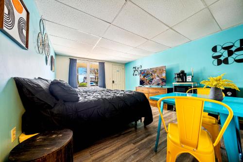 a bedroom with a bed and a table in it at Marvin Gardens Motel Old Orchard Beach in Old Orchard Beach