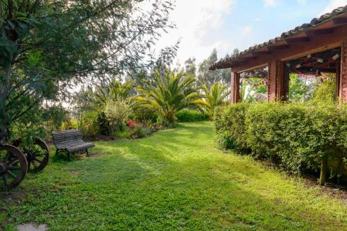 a park bench in a garden with a pavilion at Fundo San Bonifacio in Chanco