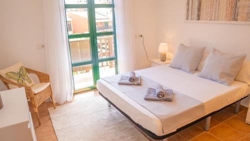 a bedroom with a bed with towels on it at Villa Luisa - Relax with Ocean View and Pool in San Miguel de Abona