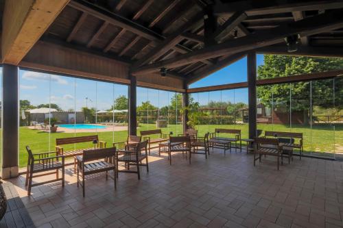 a patio with tables and chairs and a pool at Agriturismo Bonaventura in Montefiascone