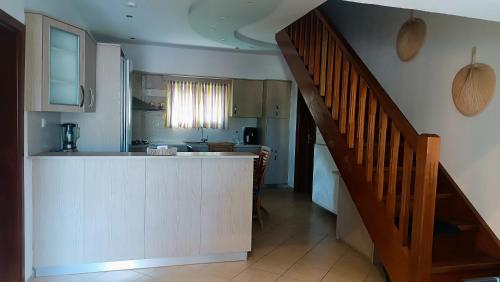 a kitchen with a counter top and a staircase at Lyra's house in Skiathos Town