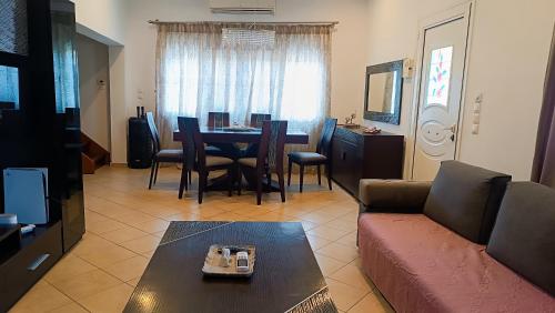 a living room with a couch and a table at Lyra's house in Skiathos Town