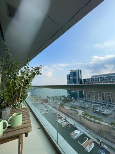 a balcony with a view of a city with cars at 2BR with Breathtaking Sea View Yas Proximity in Abu Dhabi