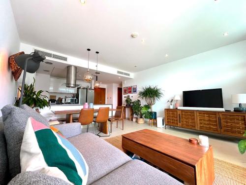a living room with a couch and a table at 2BR with Breathtaking Sea View Yas Proximity in Abu Dhabi