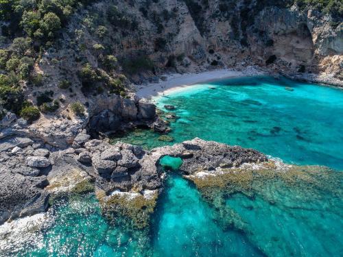 an aerial view of a beach with turquoise water at Icore a mare IUN T7289 in Cala Gonone