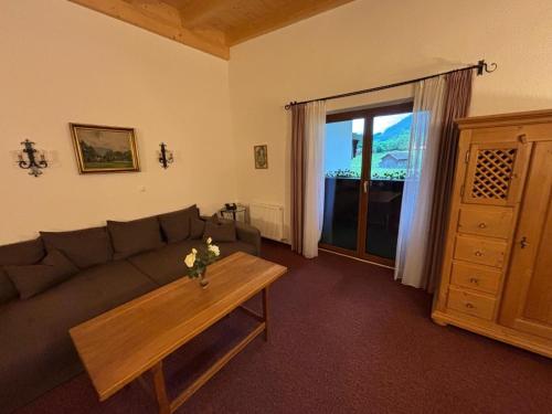 a living room with a couch and a coffee table at Hotel Rosengarten in Neustift im Stubaital
