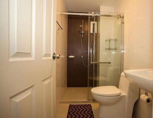 a bathroom with a shower and a toilet and a sink at The Trust Condo Huahin Soi5 in Hua Hin