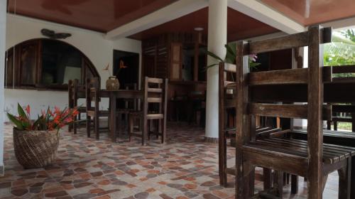 a room with chairs and a table in a room at Ecolodge Vientos de Yubarta in Nuquí