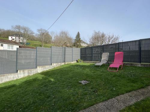 two chairs sitting in a yard next to a fence at Iagonia in Lacarry-Arhan-Charritte-de-Haut
