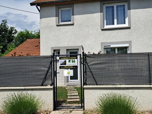 a gate with a sign in front of a house at le chemin des Bérands chambres d'hôtes Renaison in Renaison