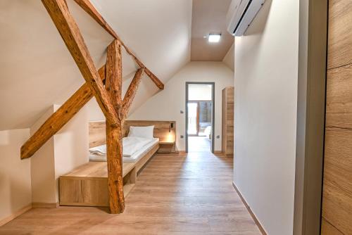 a bedroom with a bed and wooden beams at Turistična Kmetija Pungračič in Zavrč