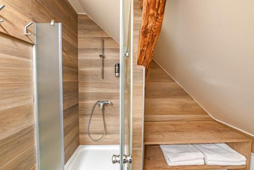 a bathroom with a shower and a bath tub at Turistična Kmetija Pungračič in Zavrč