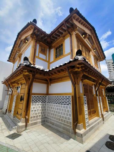 a building with a wooden structure on top of it at Insarang in Seoul