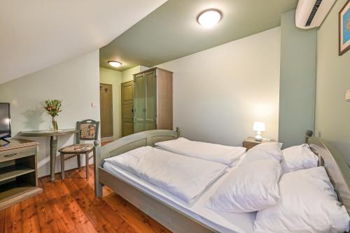 a bedroom with a large bed with white sheets at Turistična Kmetija Pungračič in Zavrč