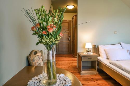a vase of flowers on a table in a living room at Turistična Kmetija Pungračič in Zavrč
