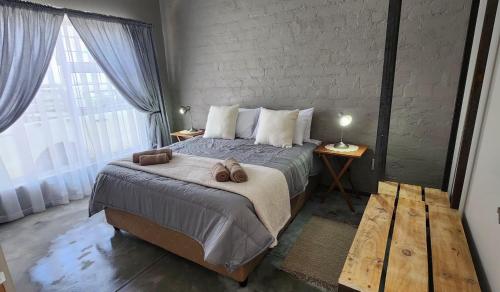 a bedroom with a bed with two towels on it at Munsterland Guest Farm in Outjo