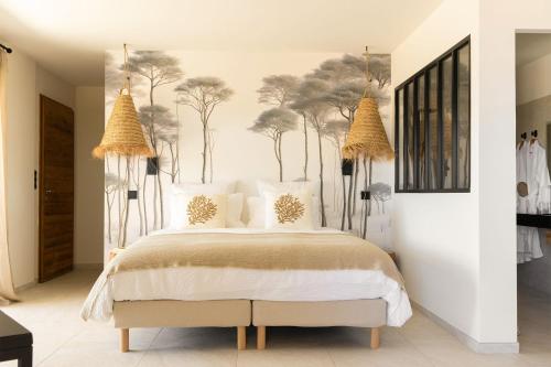 a bedroom with a bed with trees on the wall at Hôtel A Cala - Suites piscines privées et vue mer - Adults only in Favone