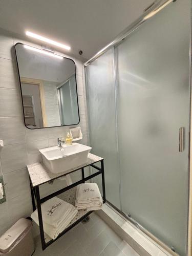 a bathroom with a sink and a shower at Filio rooms in Kythira