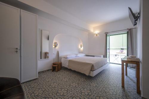 a hotel room with a bed and a large window at Scirocco Affittacamere in Oliveri