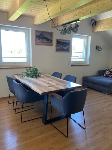 a dining room table and chairs in a living room at Ferienwohnung Mondsee-Irrsee in Tiefgraben
