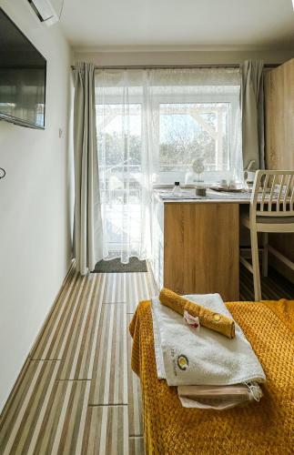 a room with a kitchen with a counter and a table at Zen House ADULT ONLY 16plus in Hajdúszoboszló