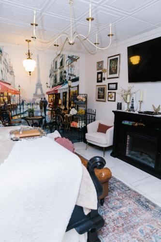 a living room with a fireplace and a tv at 5th East Hall Bed & Breakfast in American Fork