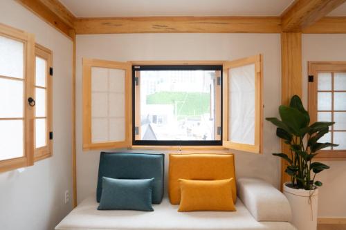 a room with two chairs and a window at Insarang in Seoul