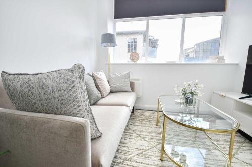 a living room with a couch and a glass table at Compact & Convenient 1 Bed Apartment in Bradford in Bradford