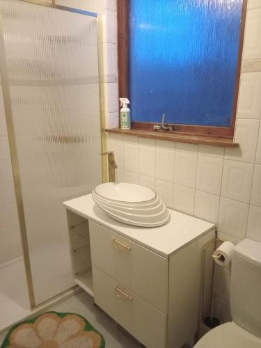 a bathroom with a toilet and a sink and a mirror at North Edinburgh - Shared house bwith own room and bathroom in Edinburgh