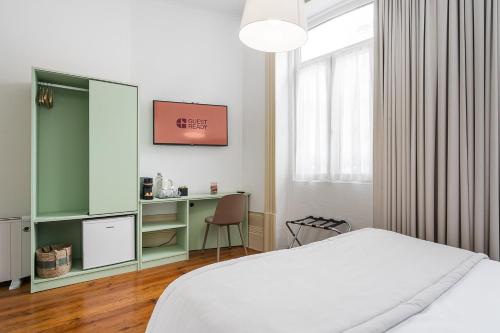 Ένα ή περισσότερα κρεβάτια σε δωμάτιο στο GuestReady - Vanzeleres Collection