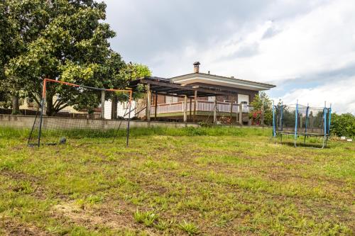 a yard with a playground in front of a house at Can Pons De Dalt Casa rural a la Selva in Girona