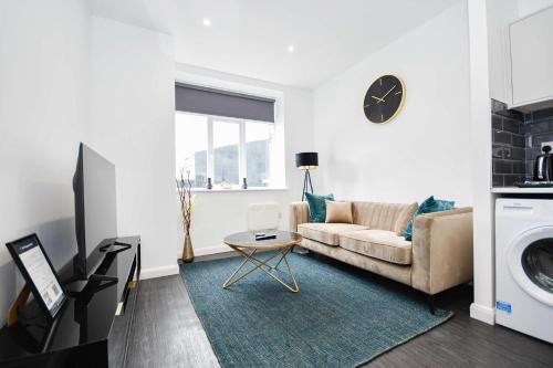 a living room with a couch and a table at Fabulous Compact 1 Bedroom Apartment in Bradford in Bradford