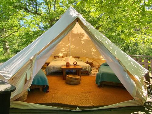 a canvas tent with two beds and a table at Podere di Maggio - Glamping tent 2 in Santa Fiora