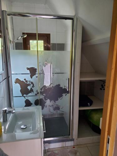 a bathroom with a glass shower with a sink at La Griotte & Spa&Piscine in Pennedepie