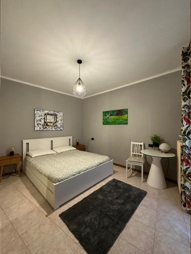 a bedroom with a bed and a table and a lamp at Appartamento a Luino Cavallotti25 in Luino