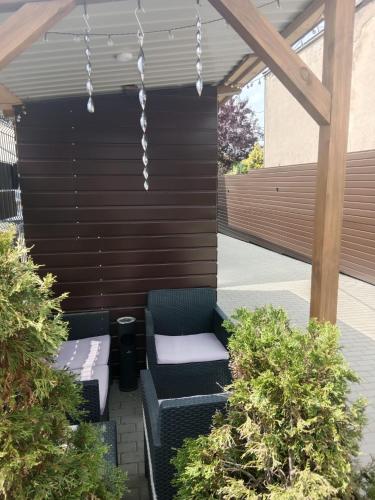 a pergola with two chairs and a bench at Mieszkanie na Wygodzie M1-parking free in Białystok