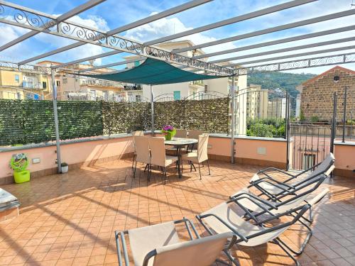 a patio with chairs and a table on a balcony at Starview Apartment - Comfy Apt by the center in Vico Equense