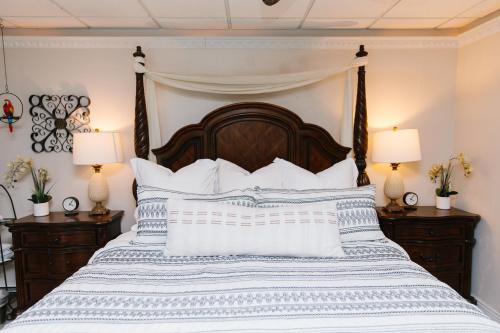 a bedroom with a large bed with blue and white pillows at 5th East Hall Bed & Breakfast in American Fork