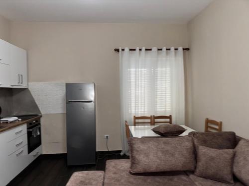una cucina con divano e tavolo con frigorifero di Best Comfort Apartment a Tirane
