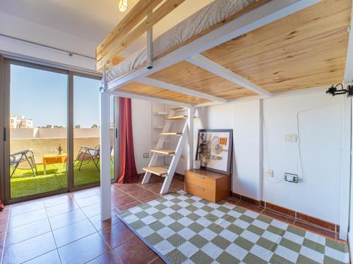 a room with a loft bed and a checkered floor at Oasis Vistamarina in El Médano