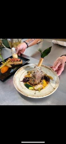 a plate of food sitting on top of a table at Gabrielle hôtel in Aiguines