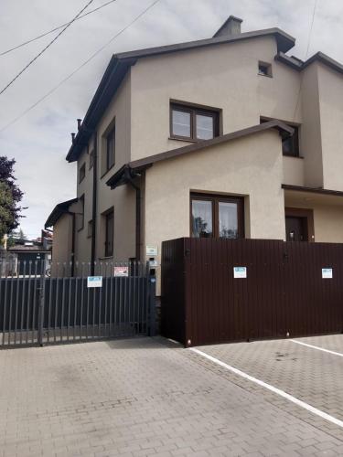 a house with a fence in front of it at Mieszkanie na Wygodzie M2-parking free in Białystok
