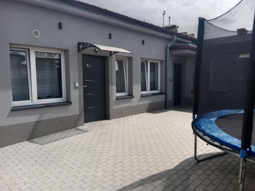 a patio with a blue slide in a house at Mieszkanie na Wygodzie M2-parking free in Białystok