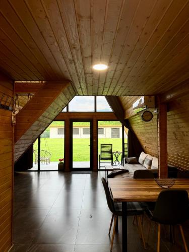 a large room with a wooden ceiling and a table at VVV House in Avrig