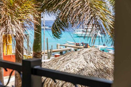 a view of a beach with a boat in the water at Elegancia Ocean View with Cooling Pool in Kralendijk