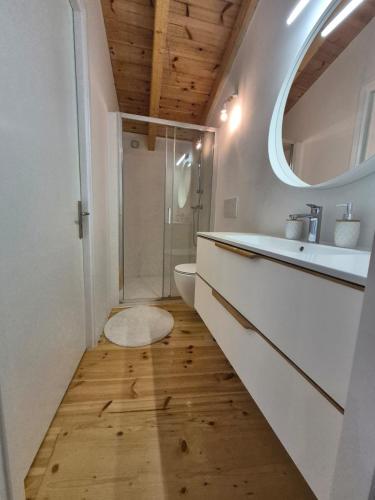 a bathroom with a sink and a toilet and a mirror at Beautiful Plomari Cottage in Plomari
