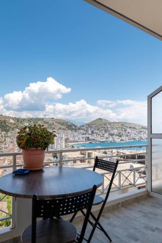 a table and chairs on a balcony with a view at Mariana Apartments in Sarandë