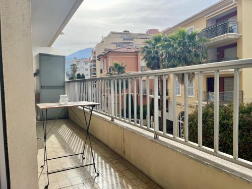 d'un balcon avec une table et certains bâtiments. dans l'établissement Central & Cosy Menton 2 pièces, à Menton